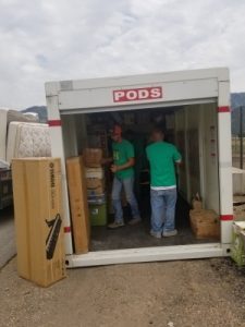 Heavy Lift Moving Co. movers loading a PODS container in Utah during a professional packing and moving job.