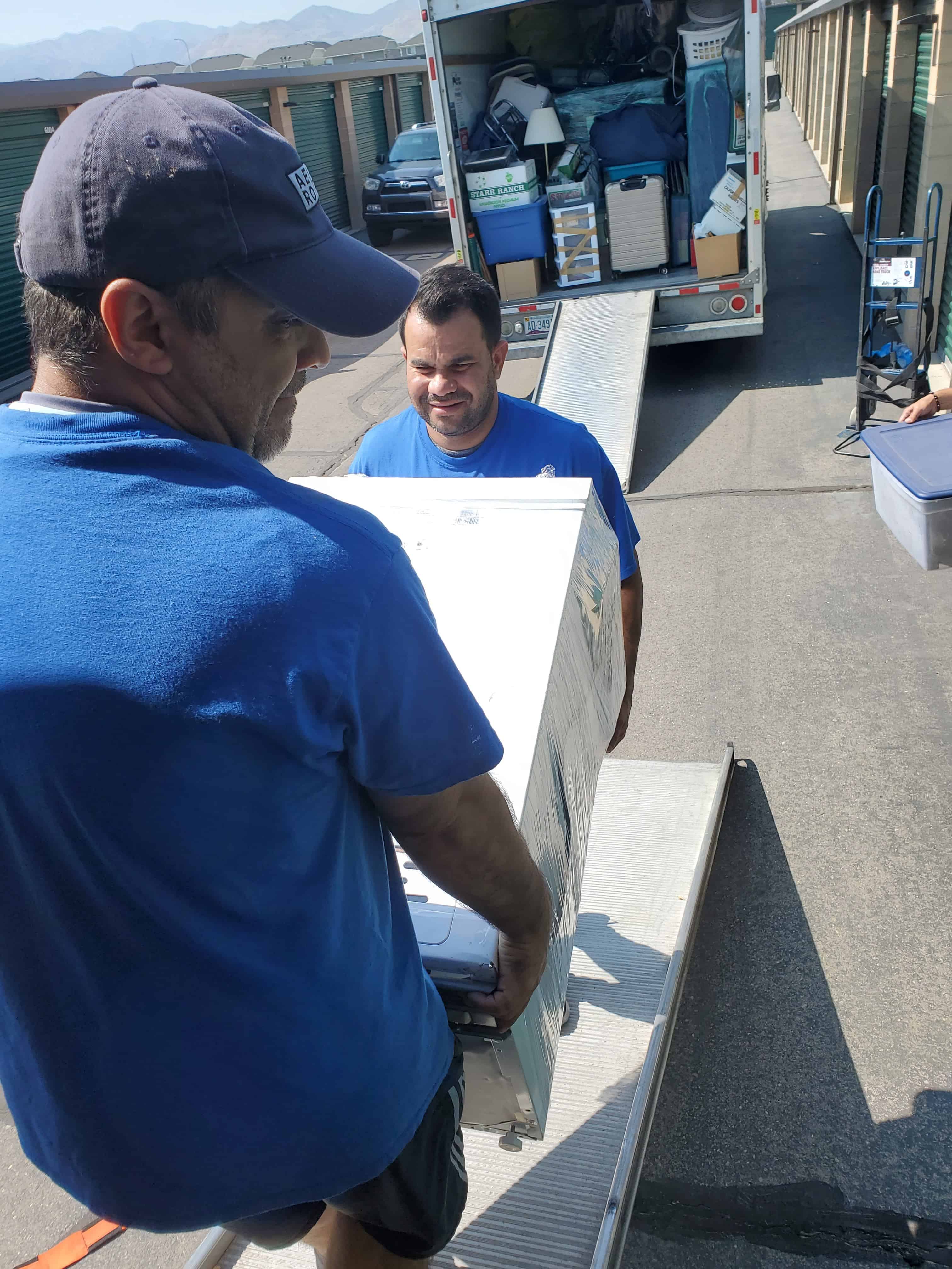 Professional mover carrying a large item during a house move in Utah