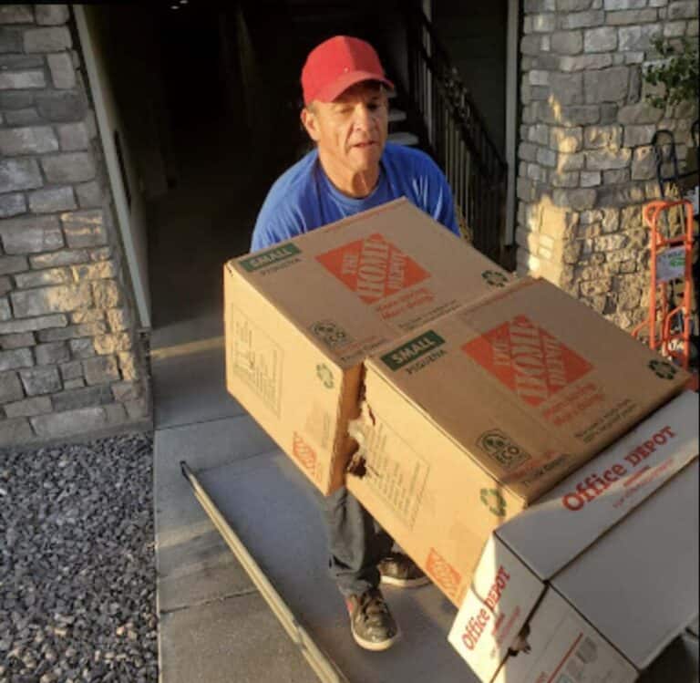 Mover carrying a large box during a house move in Utah