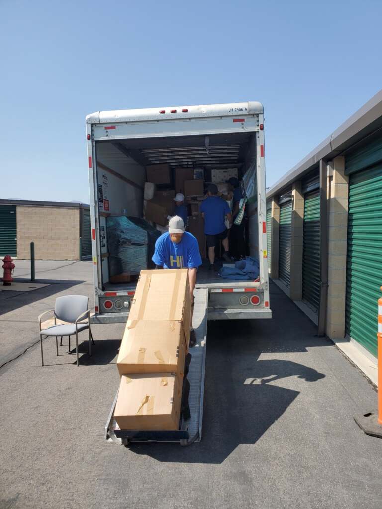 Mover securing items inside a 26-ft truck with straps